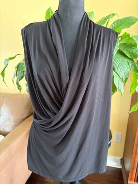 Sophia Vergara sleeveless black top. 
With crisscross draped front, flattering!